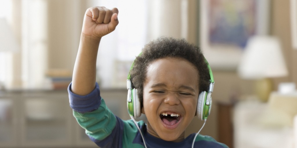 Black boy listening to music on headphones